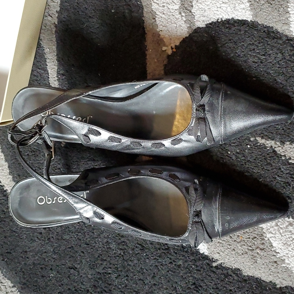 Black leather pumps with ribbon bow detailing